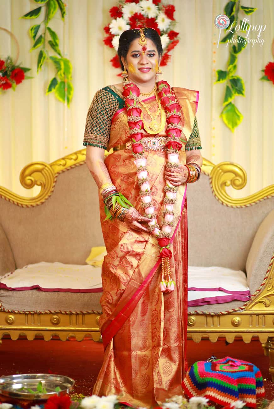 Chennai baby shower celebration captured in traditional dress, adorned with festive floral decorations.