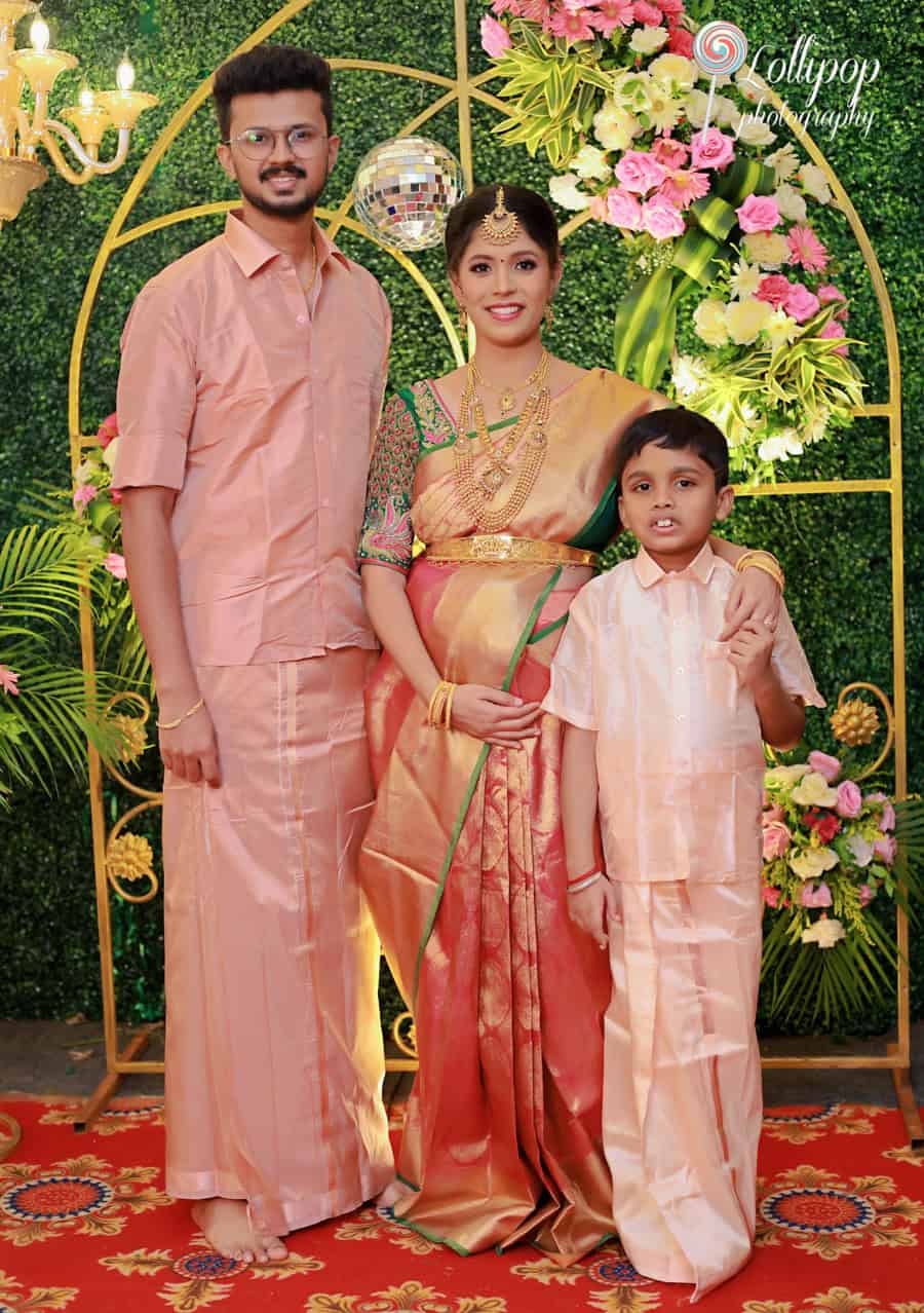 A family photo capturing a smiling mother in a traditional saree, showcasing a festive outdoor setting in Chennai.