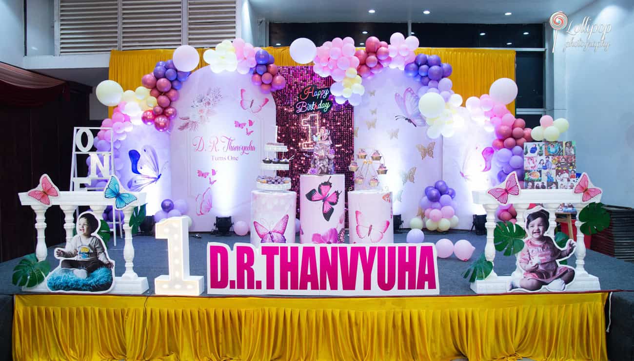 Lavish birthday setup for a first birthday party in Chennai showcasing balloons, personalized decor, and photo displays, all under the expert lens of Lollipop Photography.