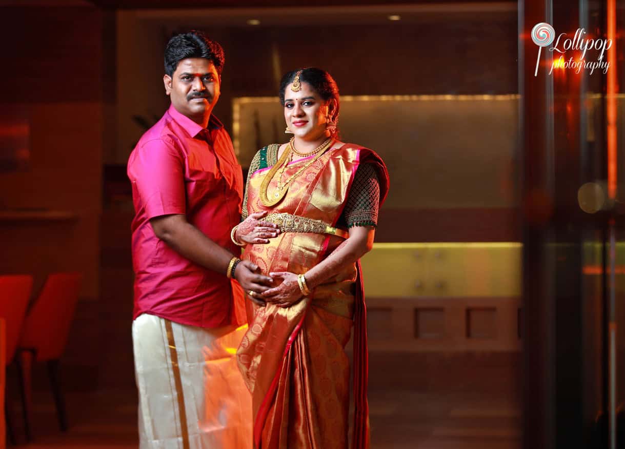 Couple in traditional Indian attire at a baby shower photo session in Chennai, showcasing a serene moment of togetherness.