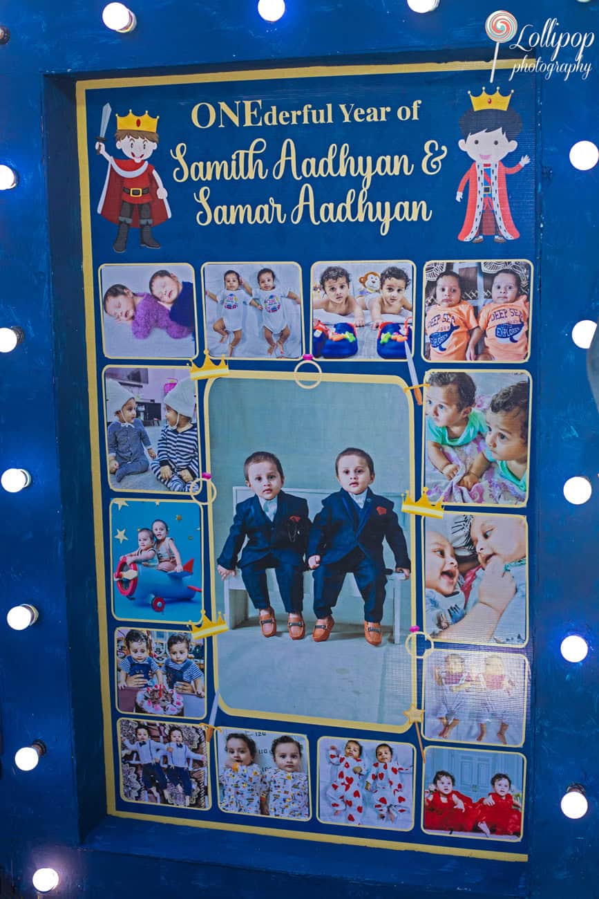 Colorful memory board displaying photos from a year of growth, titled 'ONEderful Year of Samith Aadhyan & Samar Aadhyan', celebrating twins' first birthday in Chennai.