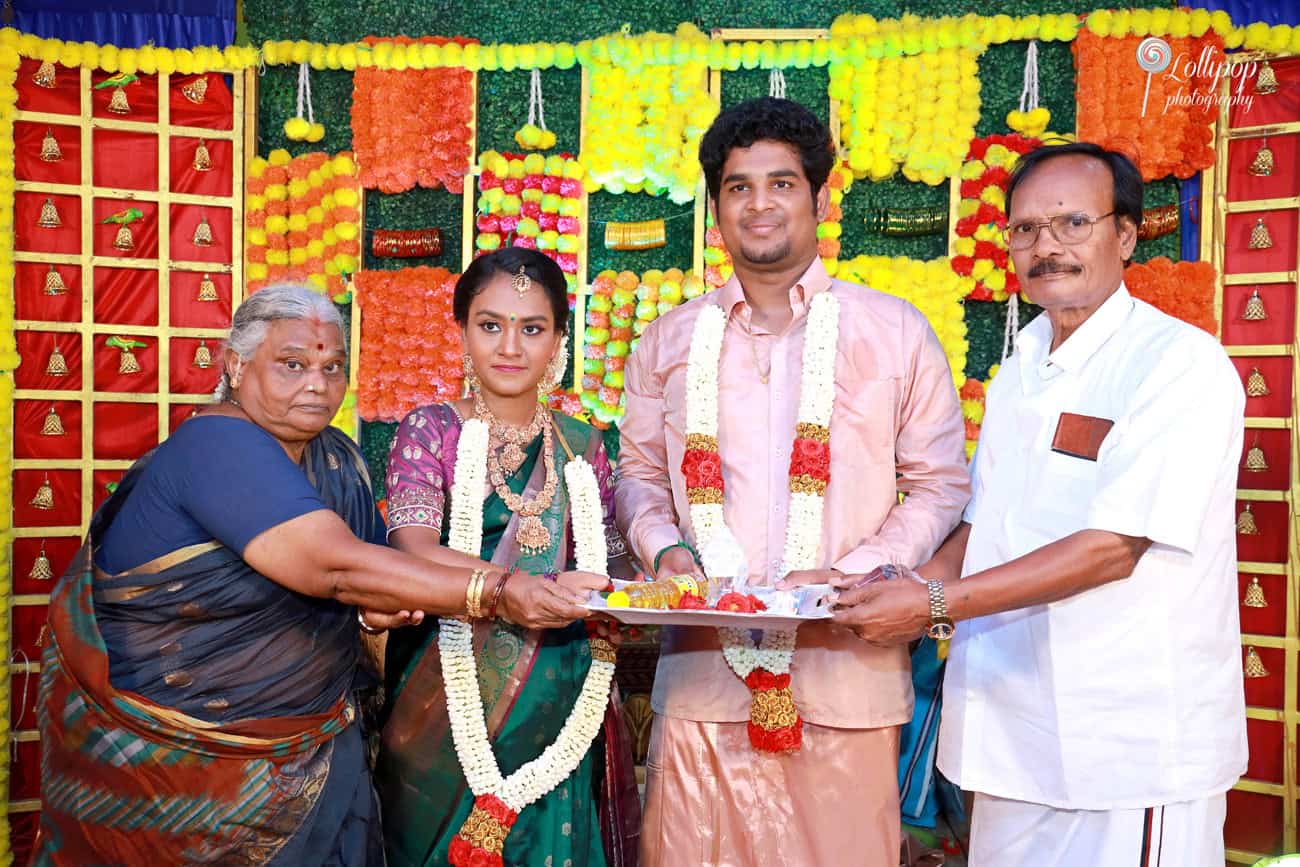 Family gathering at a baby shower, with multiple generations coming together, showcasing traditional attire and decorations in Coimbatore