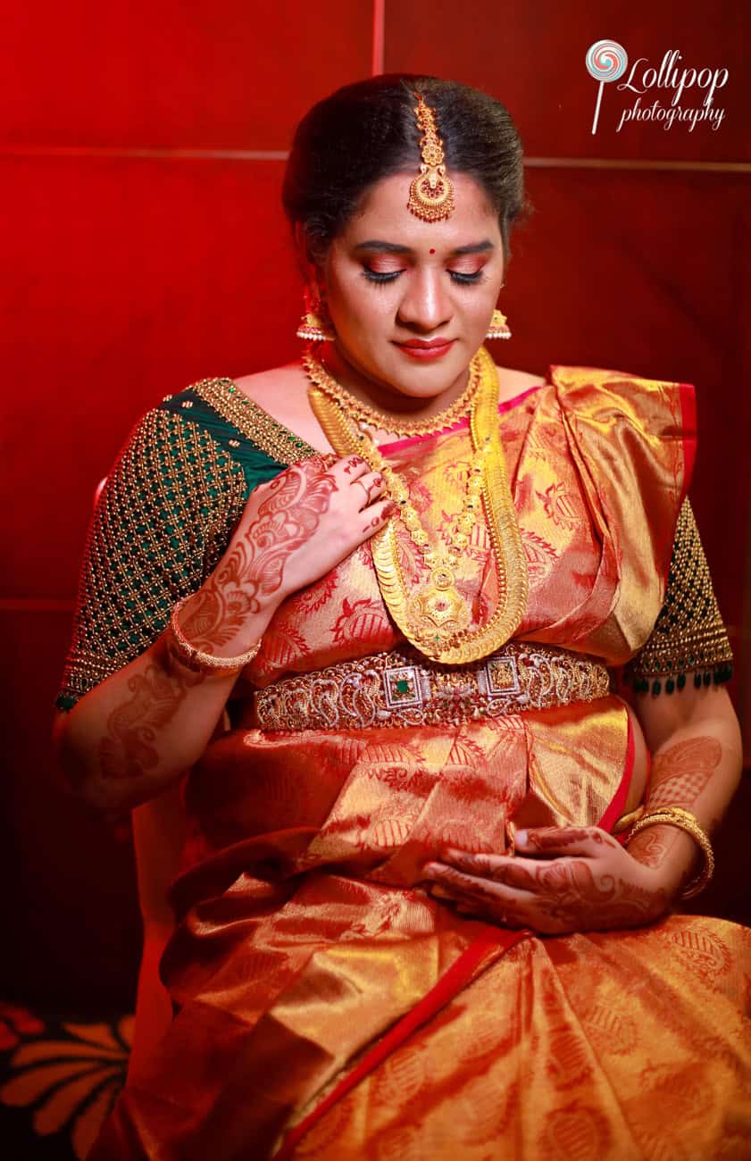 Captivating maternity session featuring a woman in traditional attire, showcasing her baby bump in Chennai.