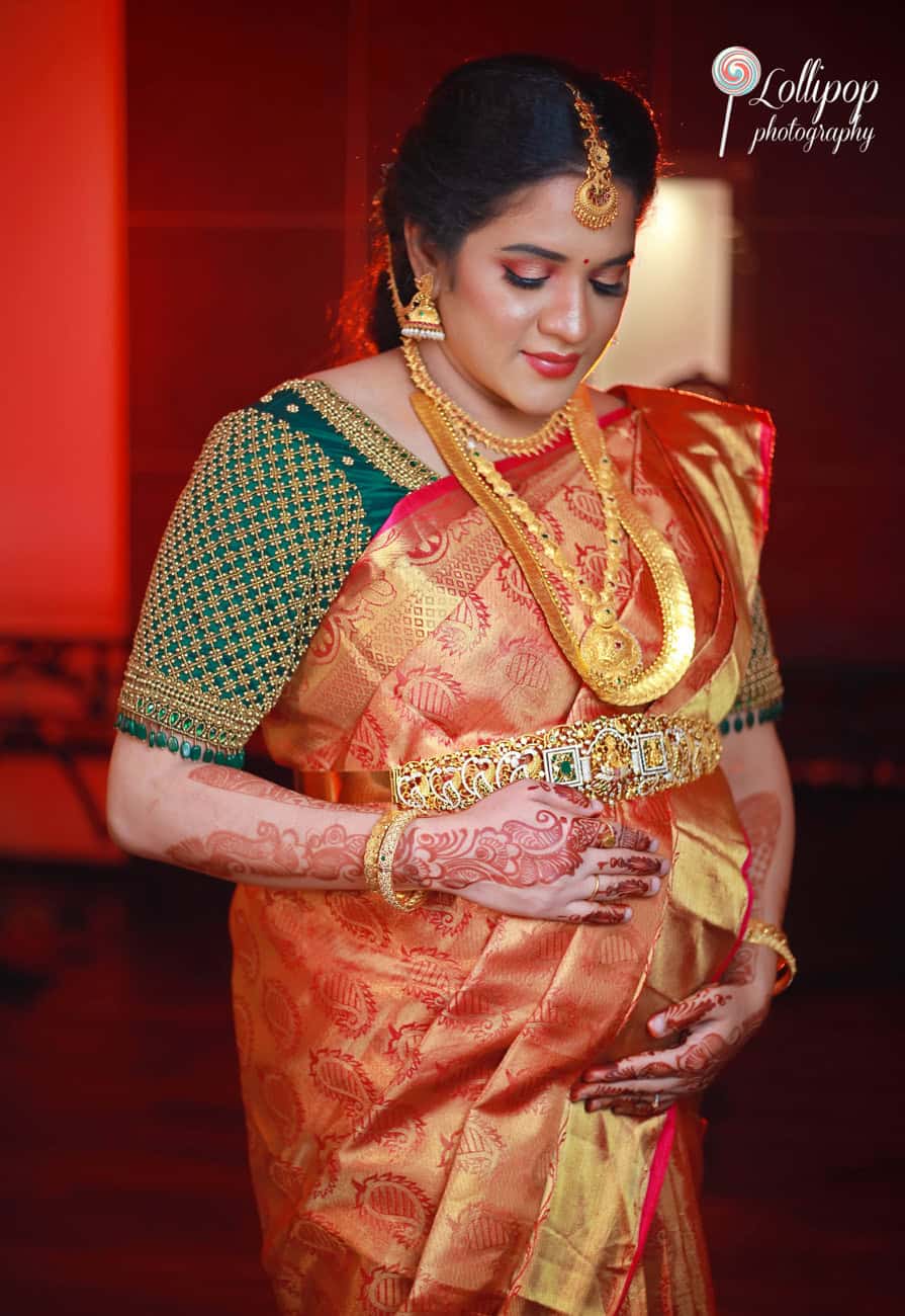 Radiant mother-to-be wearing a luxurious saree, celebrating her pregnancy with a stylish shoot at Lollipop Photography, Chennai.