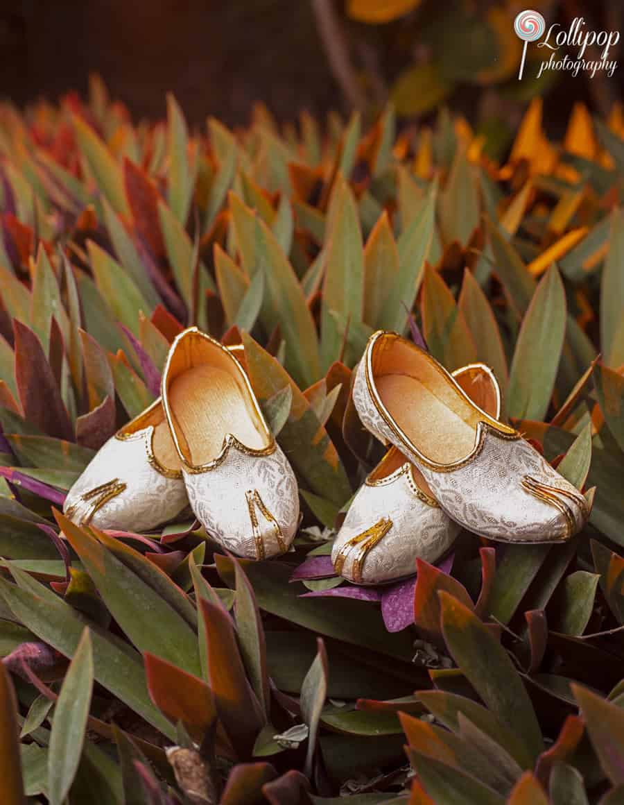 Decorative gold shoes placed amidst vibrant foliage, adding a touch of elegance to the birthday celebration decor in Chennai