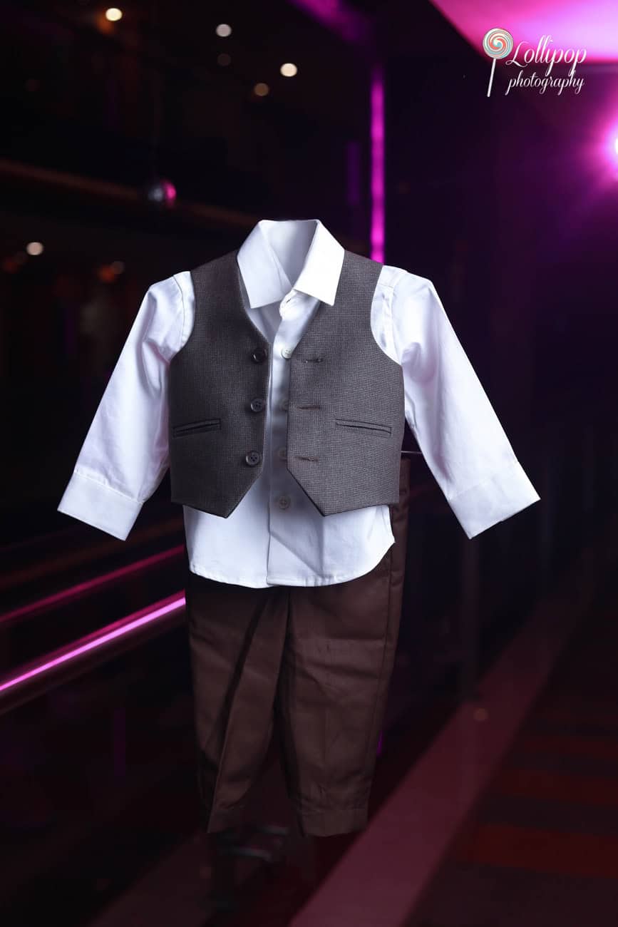 Aryan’s stylish birthday outfit displayed on a hanger, showcasing the classic vest and trousers for his celebration, captured by Lollipop Photography