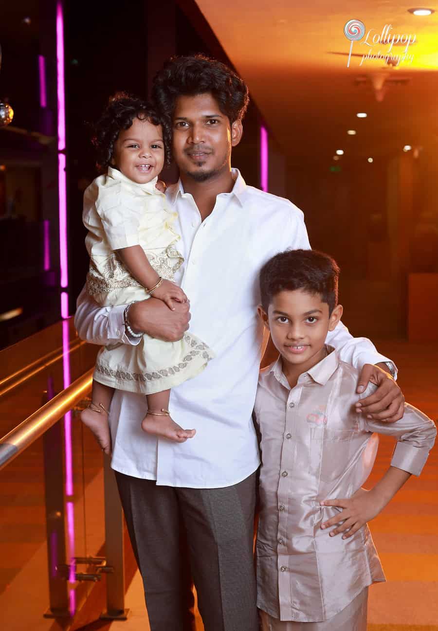 A joyful moment with Aryan in the arms of a relative, sharing smiles with his older brother, beautifully captured by Lollipop Photography