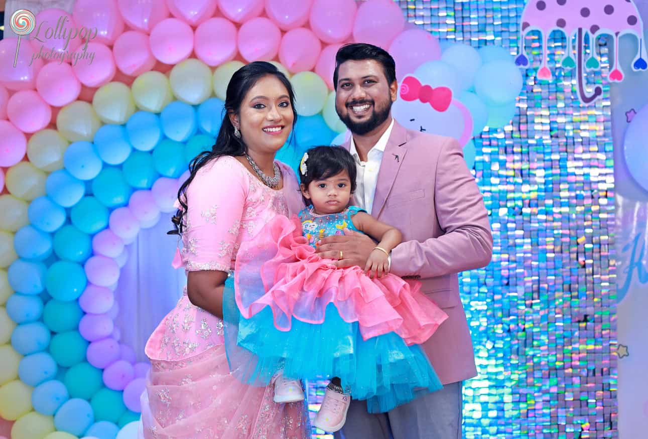 A family portrait celebrating Kanali's birthday with a pink and blue balloon backdrop by Lollipop Photography, Chennai.