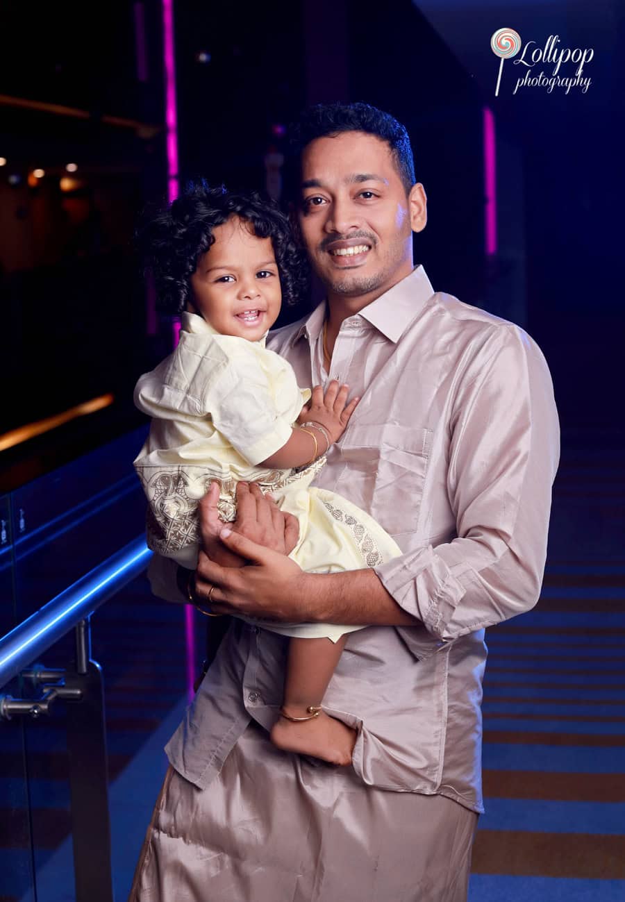 Aryan’s father holding him close with a smile during the birthday celebration, a heartwarming capture by Lollipop Photography