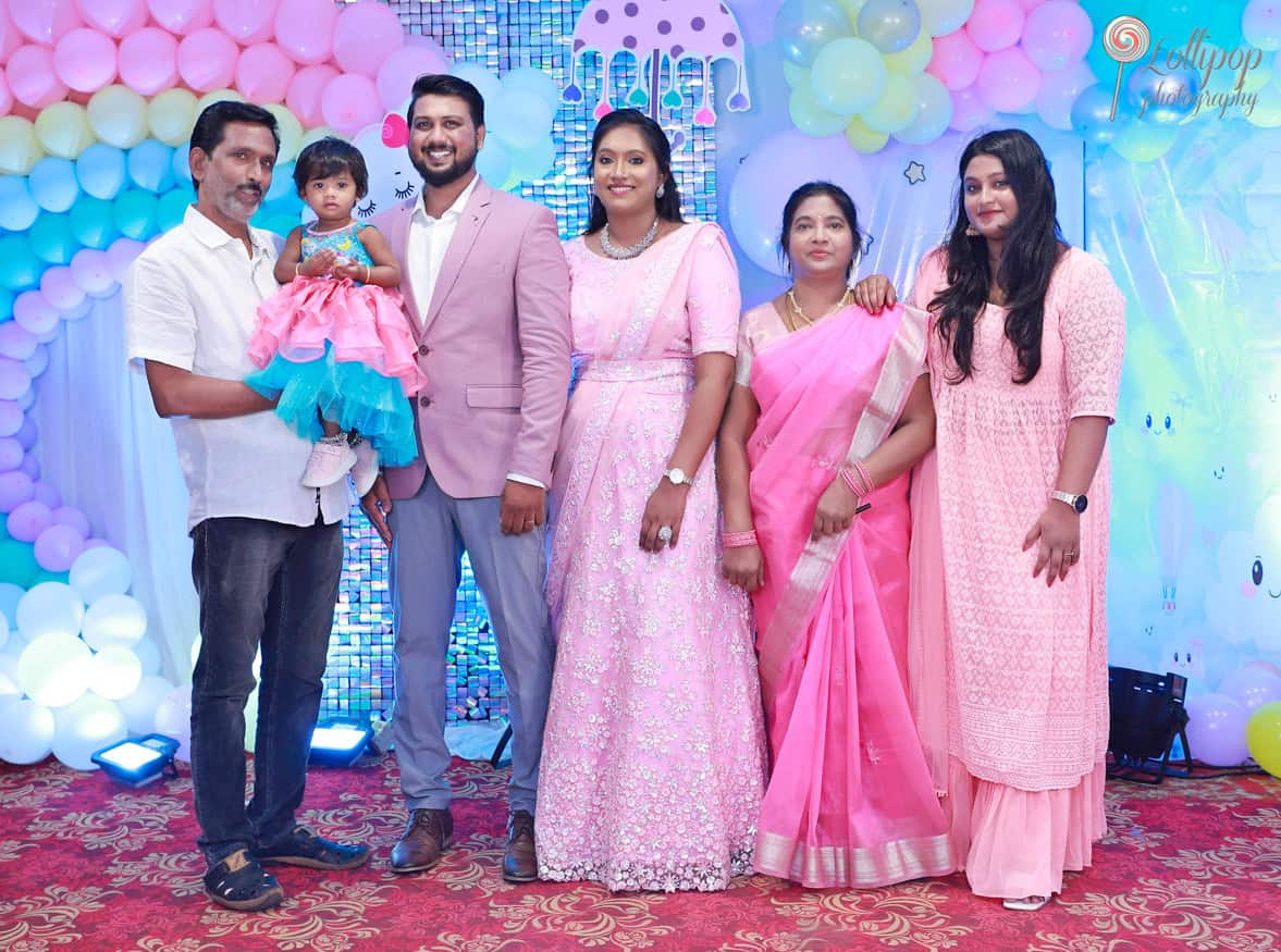 Three generations gathered for Kanali's birthday celebration, dressed in pinks and smiles, captured by Lollipop Photography in Chennai