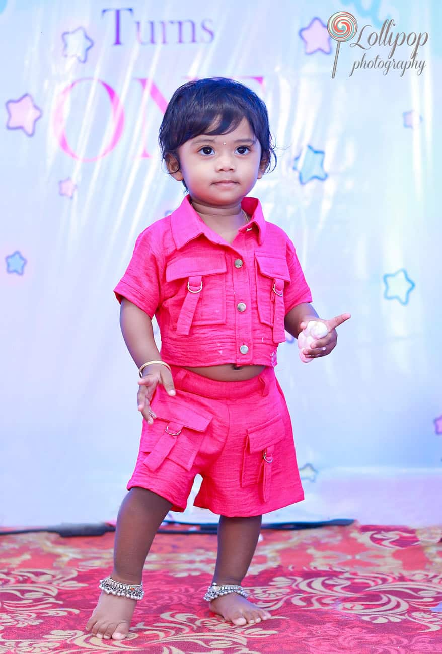 Kanali, dressed in a charming pink outfit, poses confidently on her birthday, marking a memorable moment photographed by Lollipop Photography