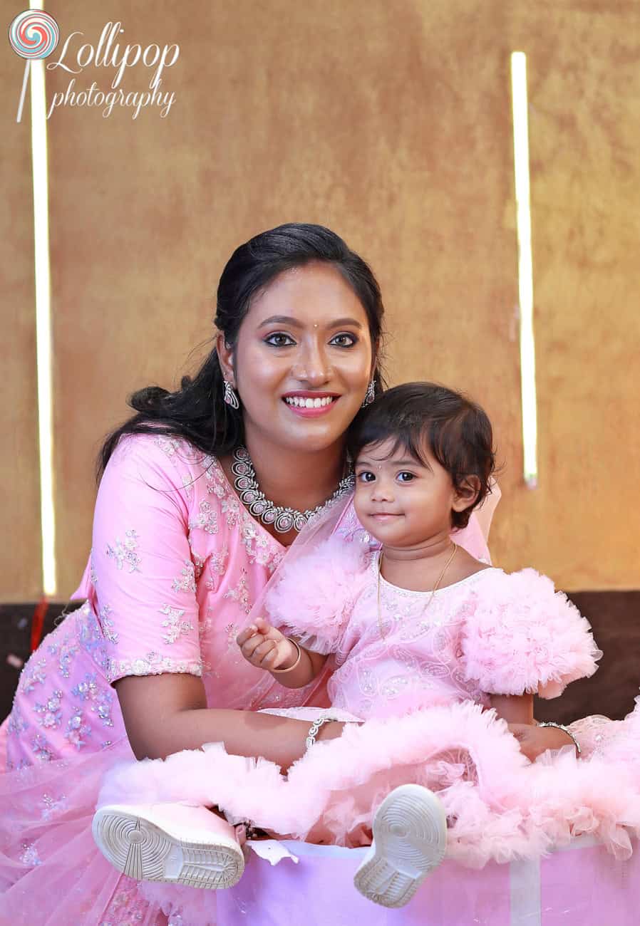 A heartwarming moment between Kanali and her mother during her first birthday celebration, expertly captured by Lollipop Photography.