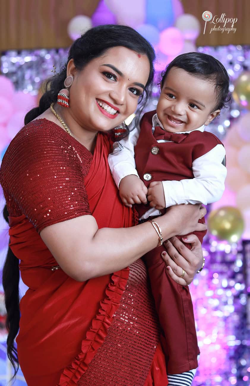 A sweet moment with Kian and his mother sharing smiles during his first birthday celebration, beautifully captured by Lollipop Photography in Chennai.