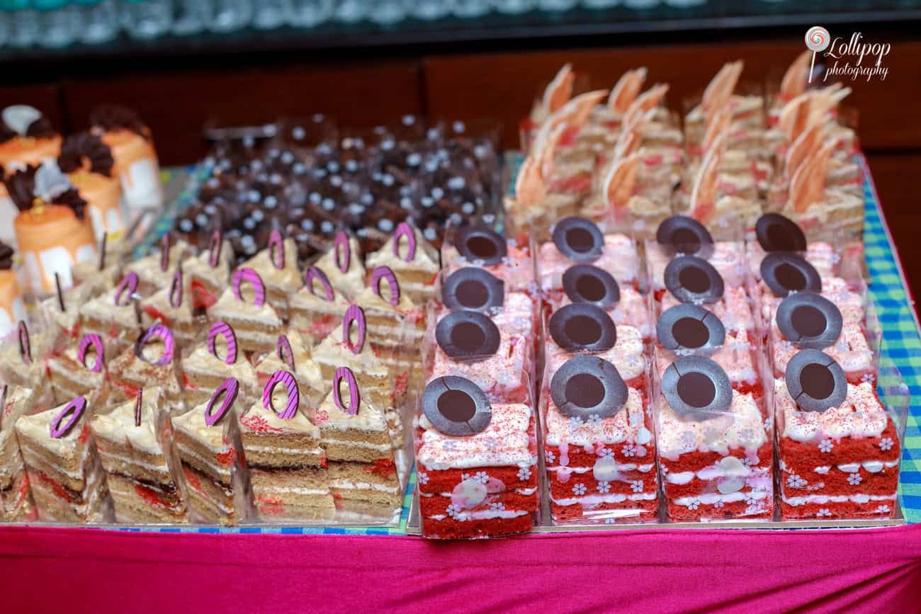 An enticing display of desserts and sweets at Nathaniel's birthday celebration, featuring colorful pastries and chocolates, captured by Lollipop Photography