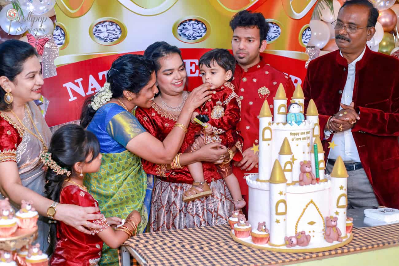 Family members share a sweet moment feeding Nathaniel a piece of his birthday cake, adding warmth to the celebration