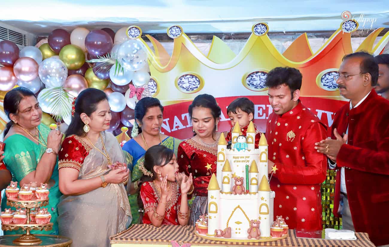 Nathaniel's family joyfully gathers around his castle-themed birthday cake, creating cherished memories together