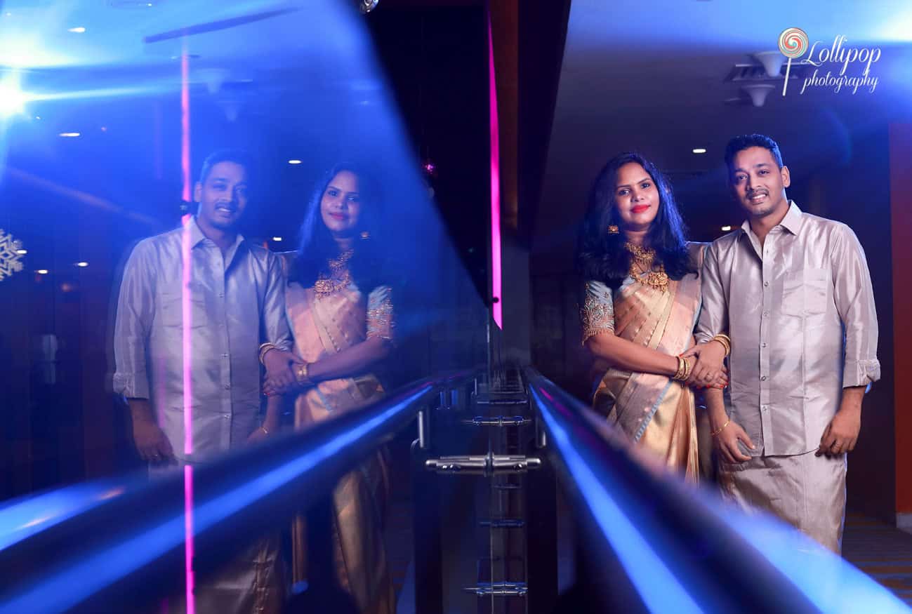 A stylish reflection shot of Aryan’s parents dressed in traditional attire, commemorating the birthday celebration, taken by Lollipop Photography