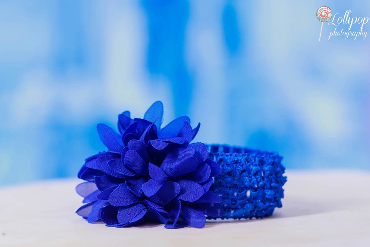 Close-up of a beautiful blue floral hair accessory, perfect for Pranika's birthday outfit, captured by Lollipop Photography