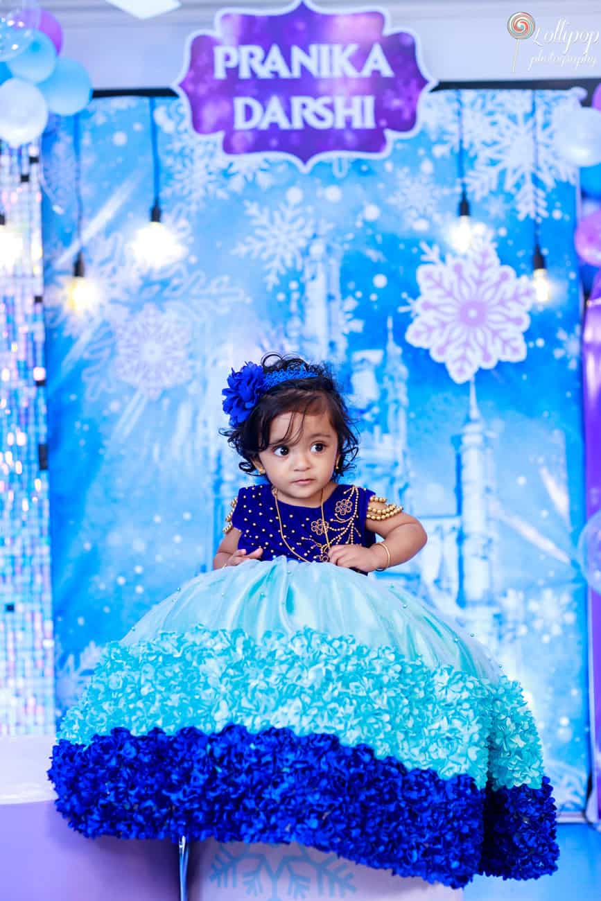 Pranika in a stunning blue and turquoise dress, celebrating her birthday in a beautifully decorated setting, captured by Lollipop Photography