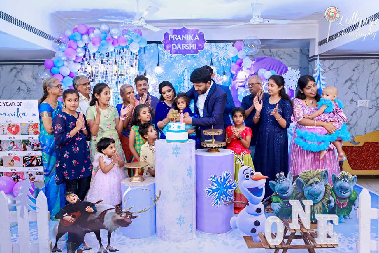 Pranika surrounded by family and friends during the cake-cutting ceremony, a memorable moment captured in Coimbatore birthday photography