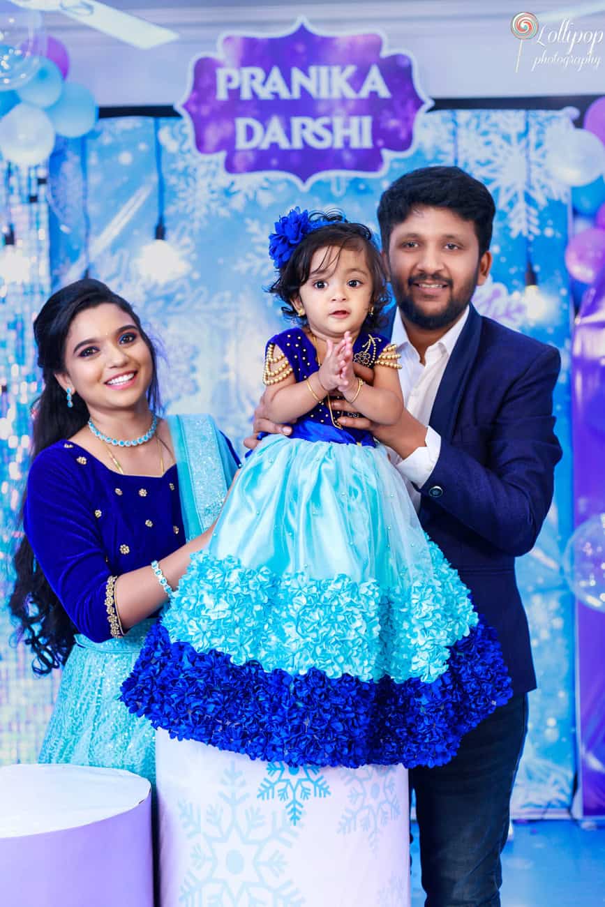 Family gathers around Pranika, dressed in a dazzling gown, for a memorable birthday celebration, captured by Lollipop Photography