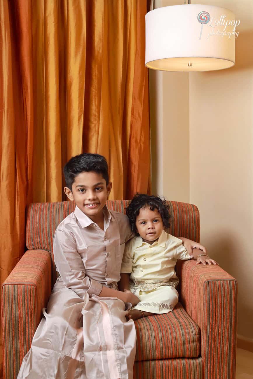 A heartwarming portrait of Aryan with his elder brother, both smiling and dressed in traditional attire to celebrate Aryan’s birthday in Chennai, captured by Lollipop Photography