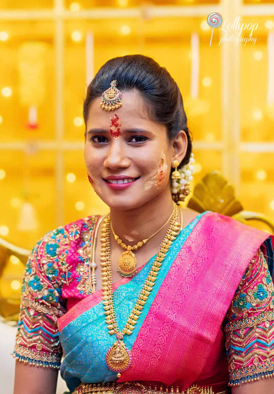 Arthi with traditional ritual face decorations during her baby shower celebration in Chennai, showcasing cultural heritage, captured by Lollipop Photography