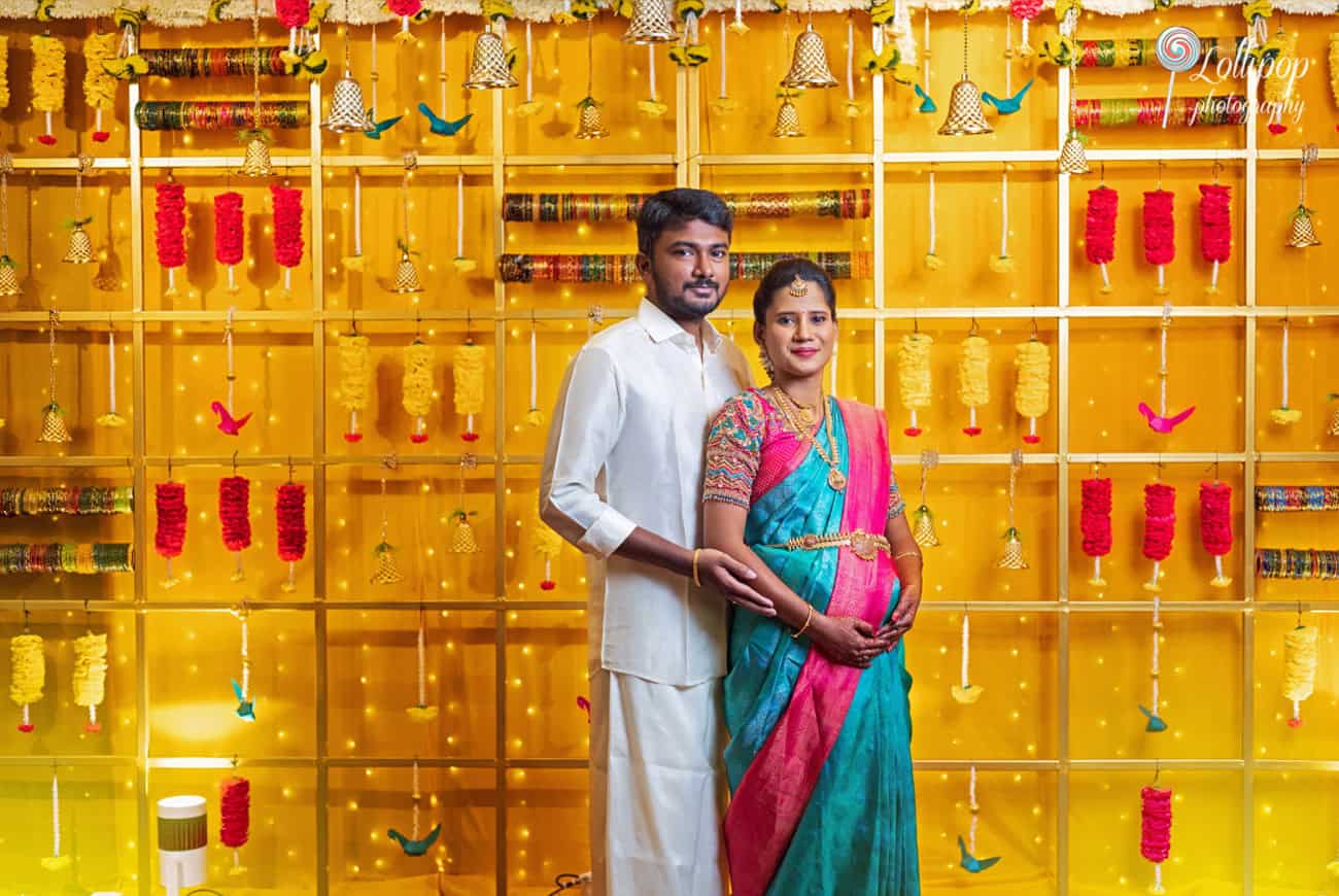 Beautifully decorated baby shower setting in Chennai featuring Arthi and Naveen Kumar, captured by Lollipop Photography