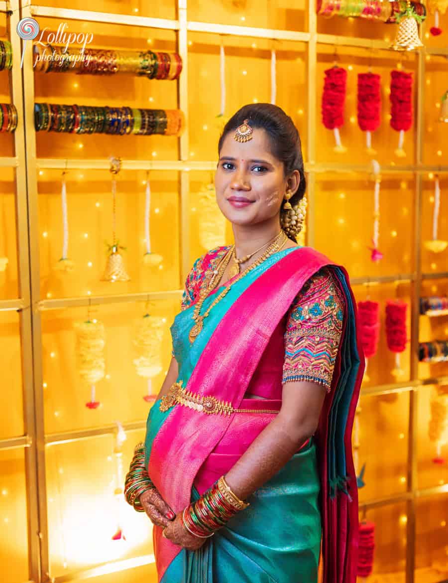 Arthi radiantly posing in traditional attire during her baby shower celebration in Chennai, captured by Lollipop Photography