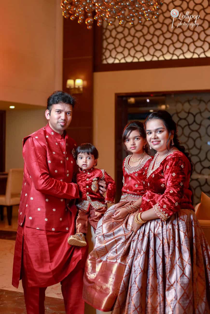 Nathaniel and family posing under a chandelier at his birthday photoshoot in a Chennai hotel.