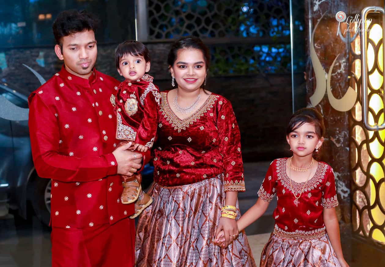 Family portrait at Nathaniel's birthday celebration in Chennai, all dressed in coordinated red and gold attire