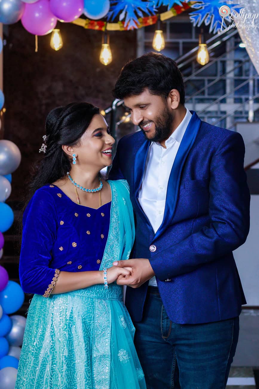 Smiling parents captured in a joyful moment at Pranika’s first birthday photography session in Coimbatore