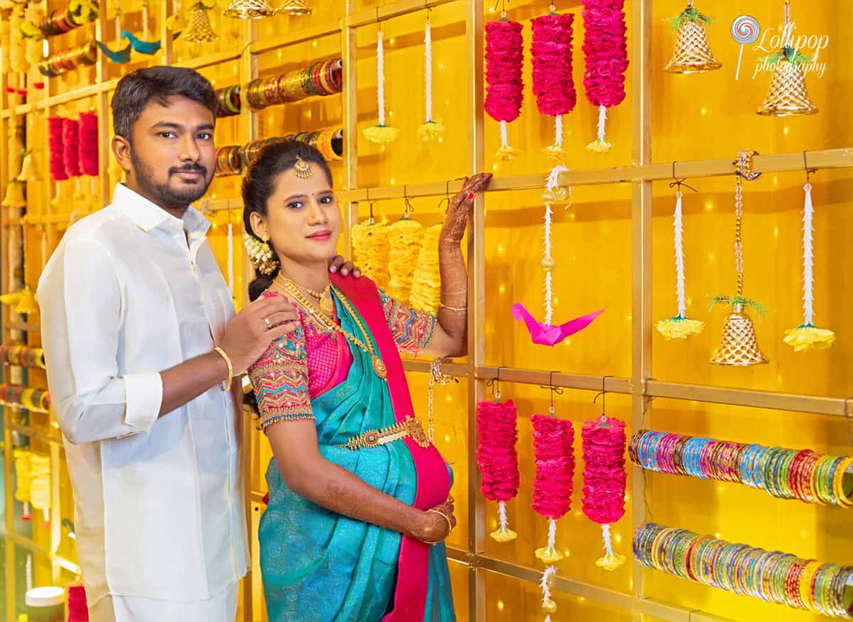 Elegant baby shower setting with traditional decorations, showcasing the couple in beautiful attire, photographed by Lollipop Photography in Chennai.