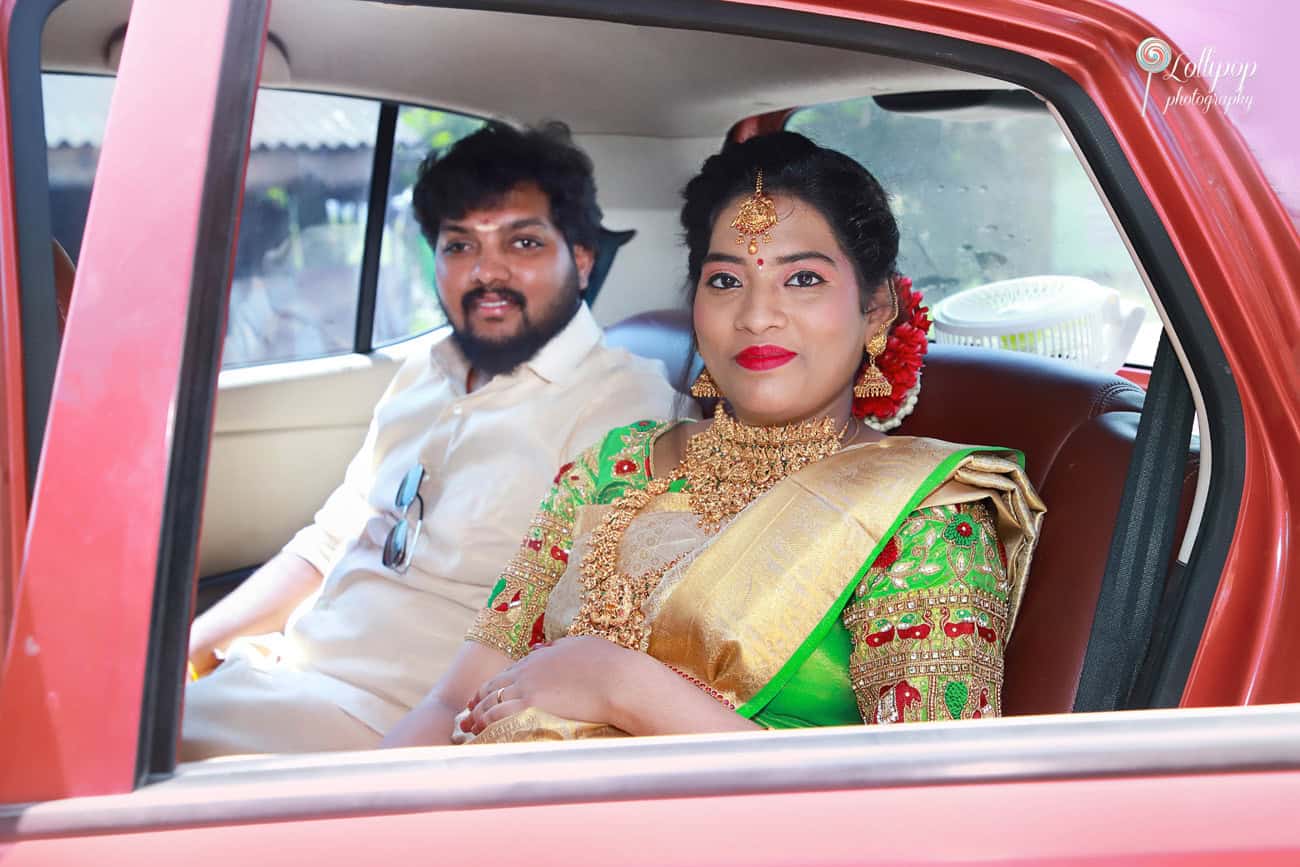 Anitha smiles from the backseat with her husband by her side, ready for her baby shower celebration in Coimbatore.