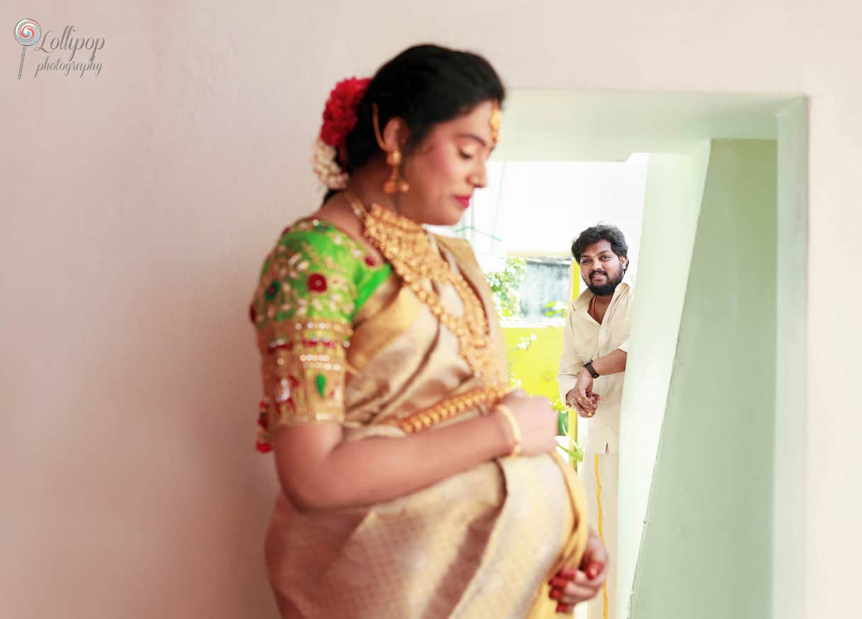 Anitha, the mom-to-be, gazes softly in a serene setting, radiating joy and anticipation for her baby, captured by Lollipop Photography in Coimbatore