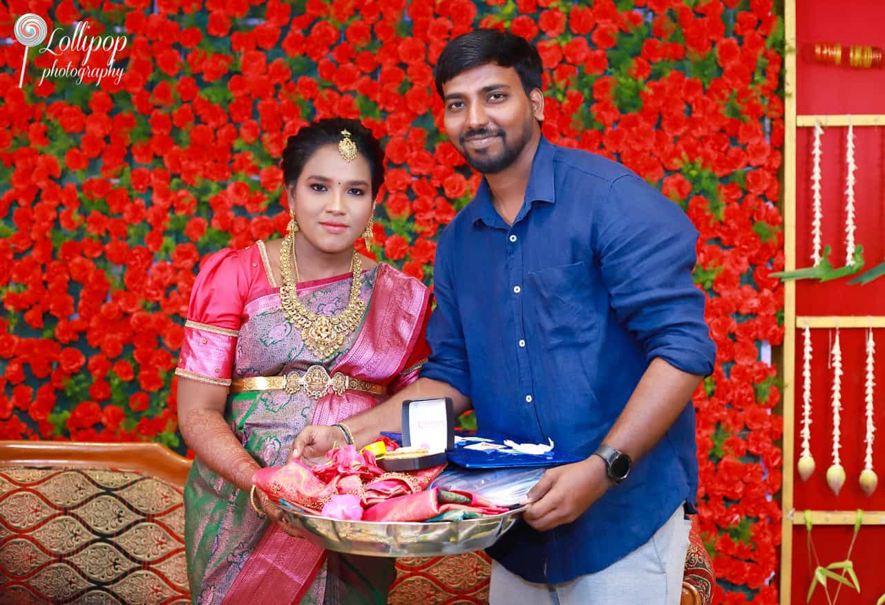 Aswini and Naresh pose gracefully as they receive blessings during the baby shower ceremony in Chennai, captured by Lollipop Photography