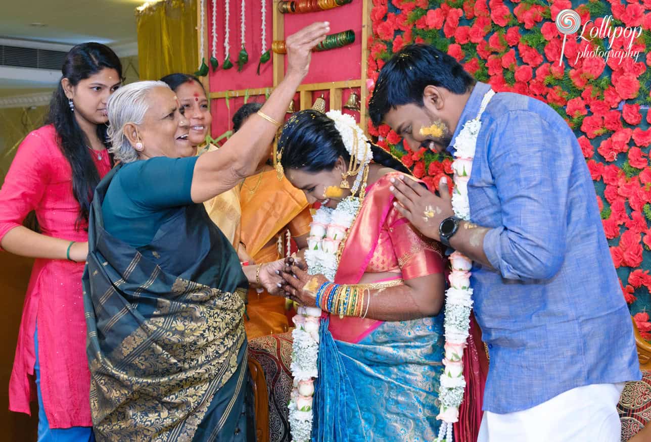 A joyful moment as the grandmother blesses the bride and groom during the baby shower ceremony, captured by Lollipop Photography