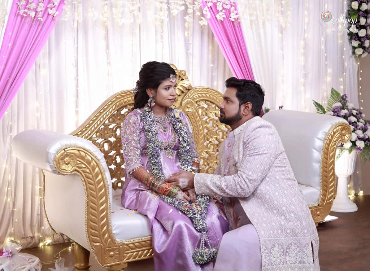 A touching moment as the groom lovingly gazes at his bride, both adorned in traditional attire, creating an intimate atmosphere at their baby shower, captured by Lollipop Photography