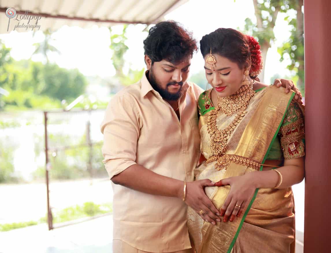 Anitha and her husband share a tender moment, bonding over the anticipation of their baby’s arrival at the Coimbatore baby shower event