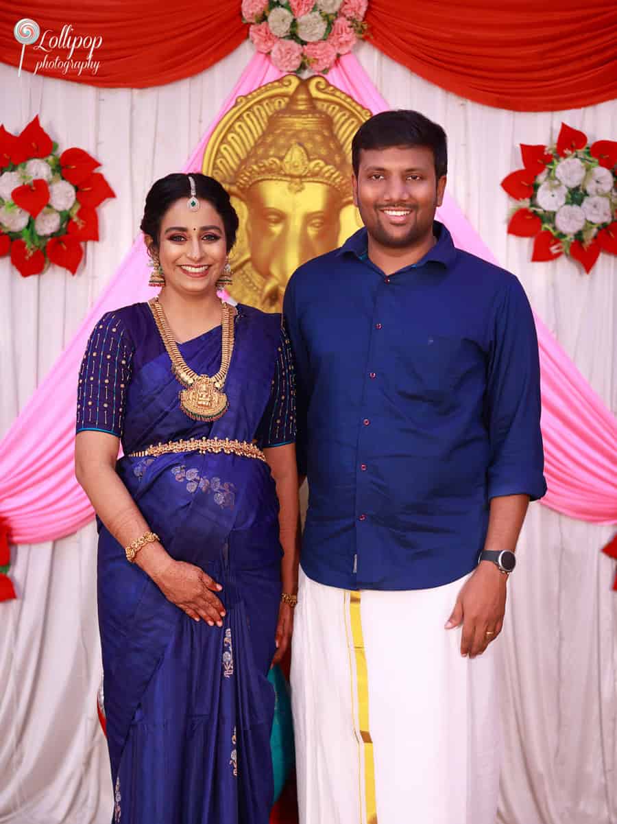 An elegant mom-to-be in a royal blue saree poses gracefully, celebrating her traditional baby shower in Coimbatore, captured by Lollipop Photography