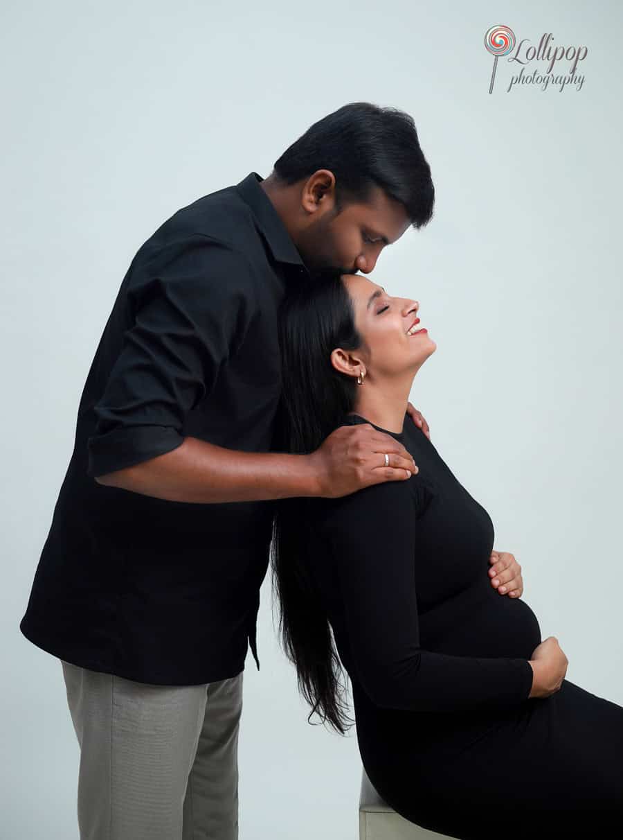 A romantic glance shared between Pavithra and her husband, capturing their love during a maternity photoshoot at their baby shower in Chennai.