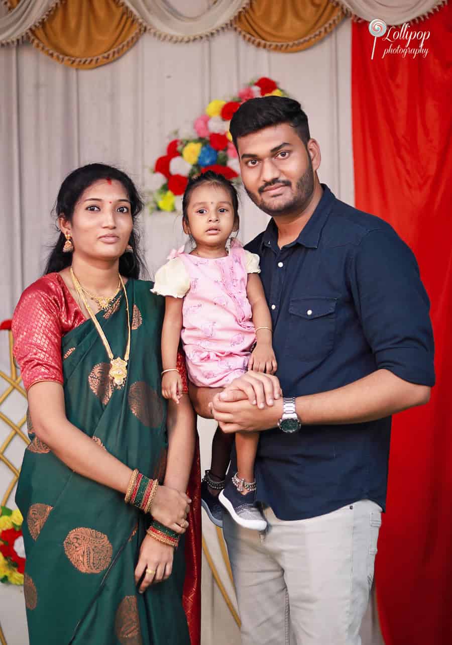 A family gathers for a portrait at Anitha's baby shower, dressed in traditional attire, celebrating the special occasion in Coimbatore.