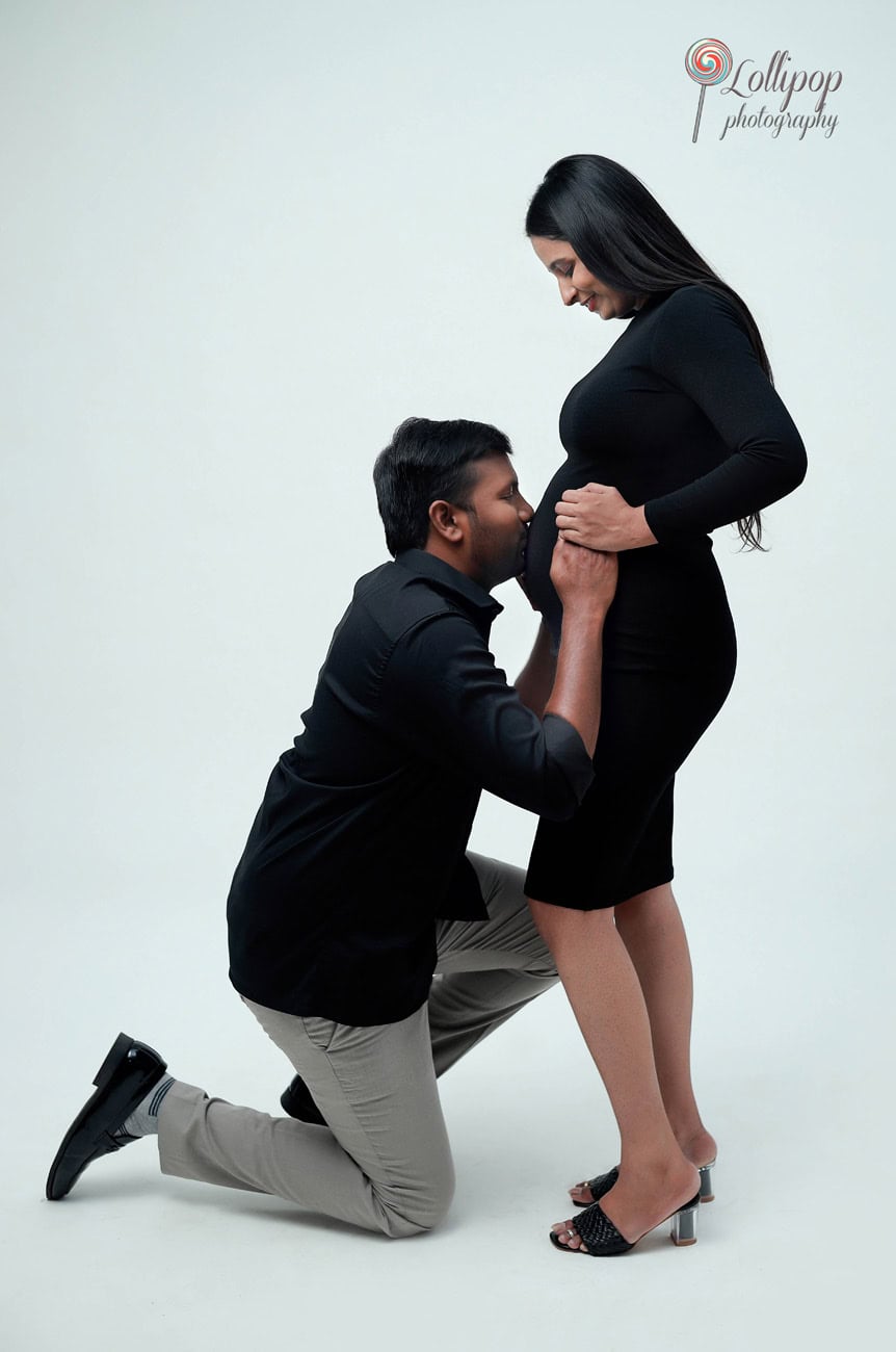 Pavithra and her husband share a relaxed portrait, celebrating the joy of parenthood in a studio maternity photoshoot by Lollipop Photography in Chennai