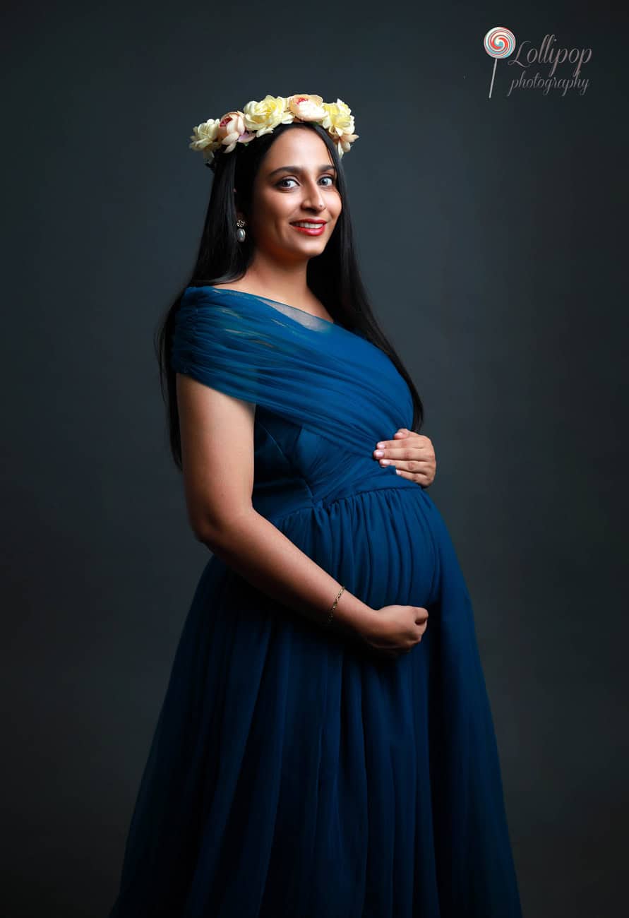 Pavithra embraces the beauty of motherhood, wearing a floral crown for an enchanting maternity photoshoot by Lollipop Photography in Chennai