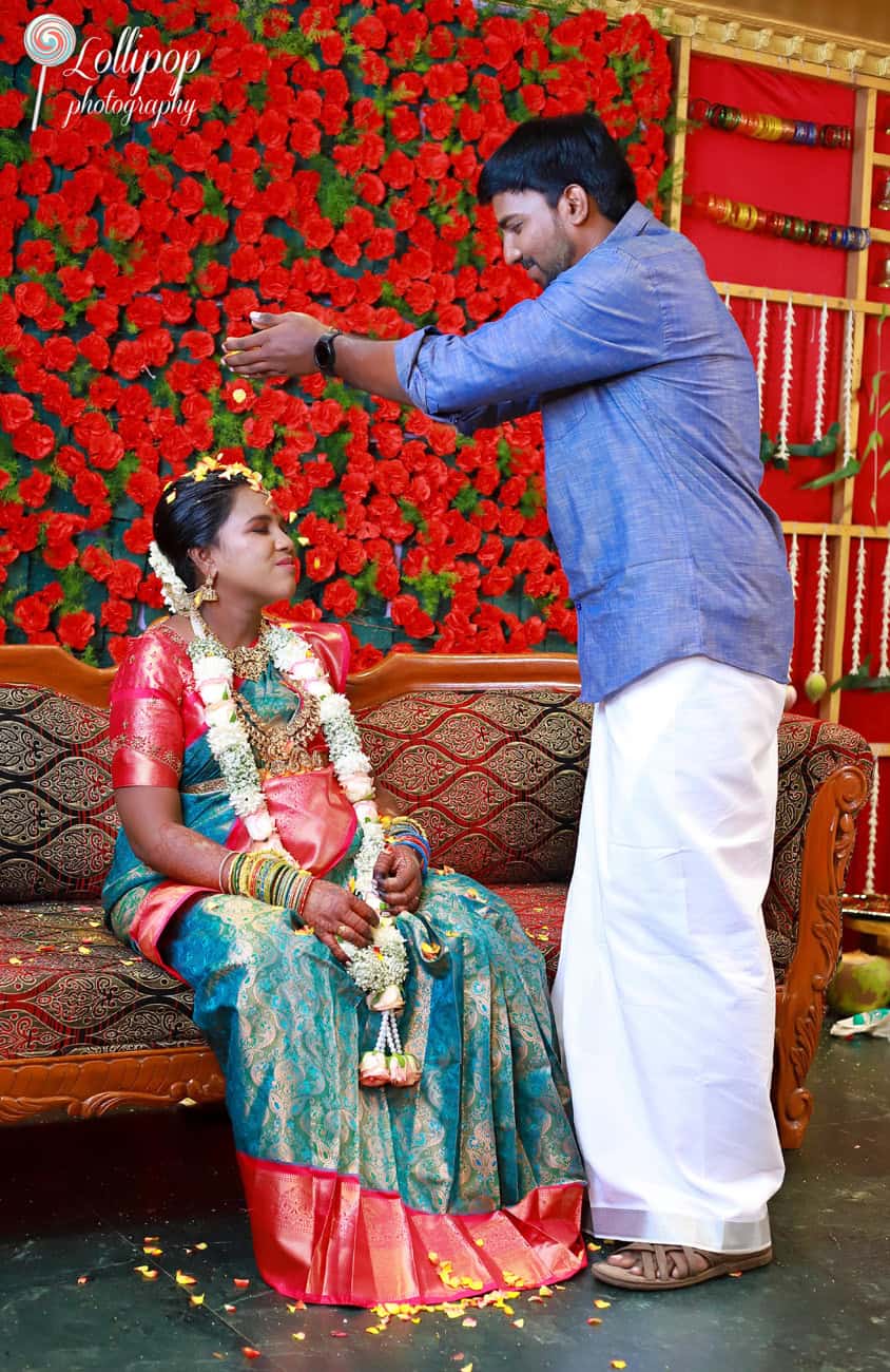 The groom showers the bride with flower petals in a beautiful display of affection and celebration, a moment of joy in the baby shower