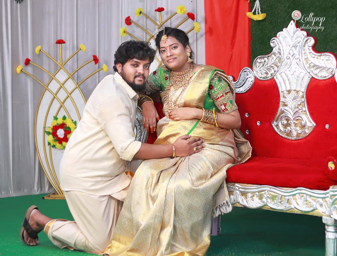 Anitha and her husband share a playful, joyful moment during the baby shower celebration in Coimbatore.