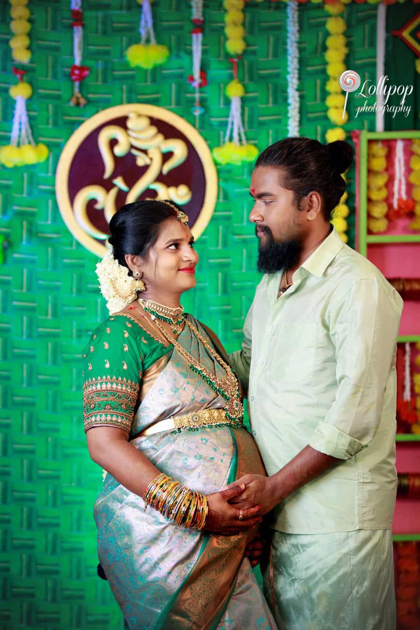 Sharmila lovingly gazes at her husband during her baby shower celebration in Coimbatore, captured by Lollipop Photography.