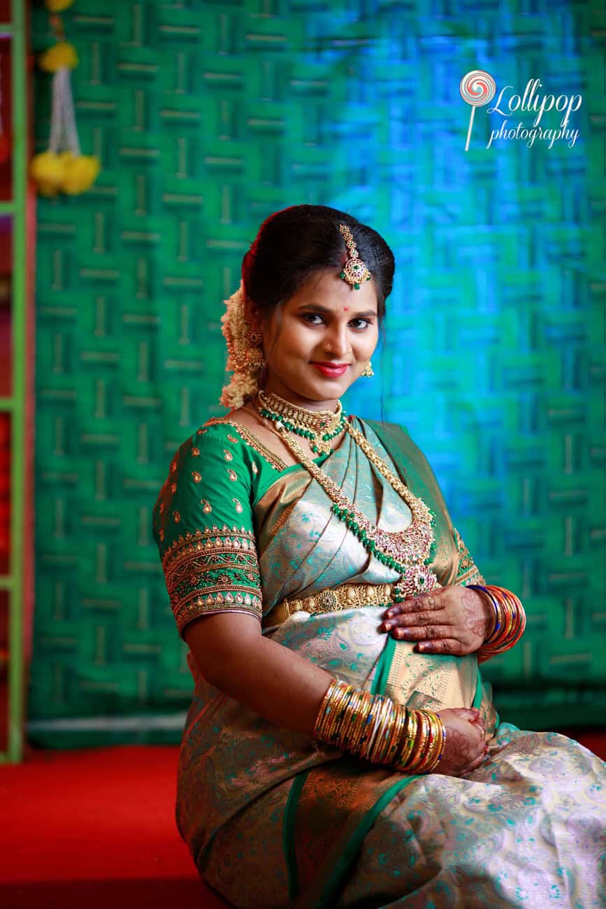 A serene Sharmila reflects the glow of motherhood during her baby shower ceremony, a touching moment by Lollipop Photography in Coimbatore