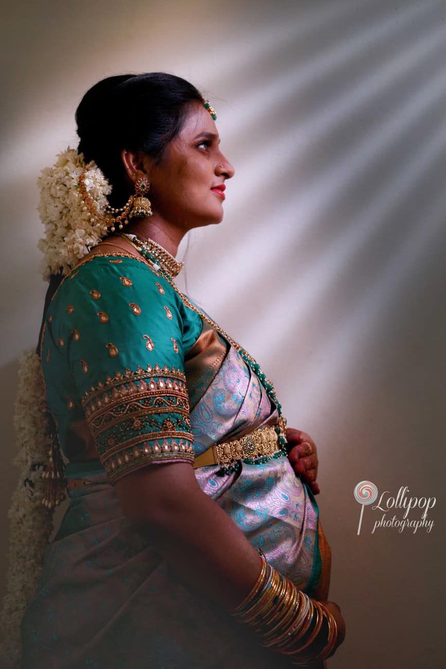 A tranquil side profile of Sharmila as she embraces motherhood at her baby shower, beautifully captured by Lollipop Photography in Coimbatore.