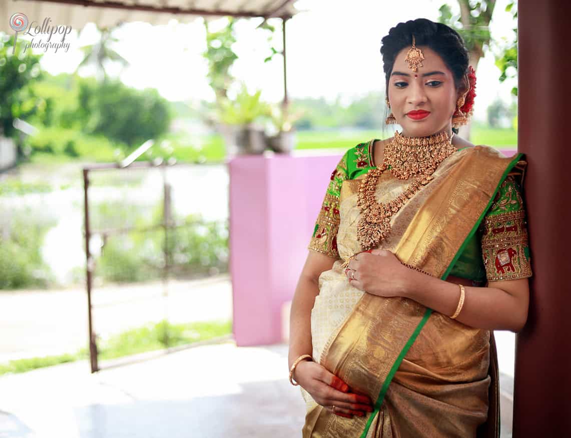 Anitha radiates joy in her traditional saree as she celebrates her baby shower in Coimbatore, a special moment captured by Lollipop Photography